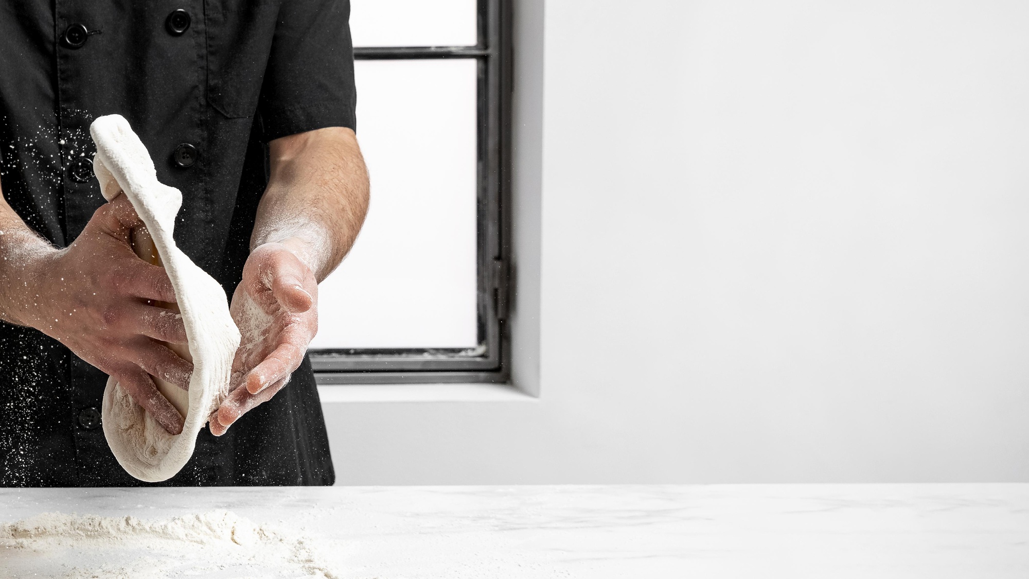 Chef hands preparing dough in warm kitchen